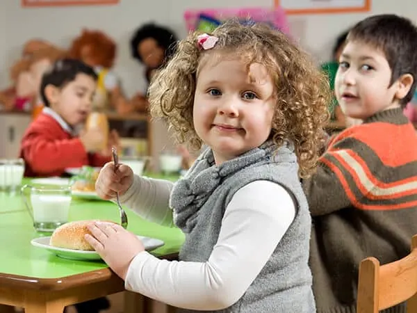 Young child Improving motor skills with family style dining