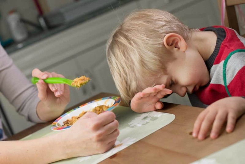 picky eater hiding face from food