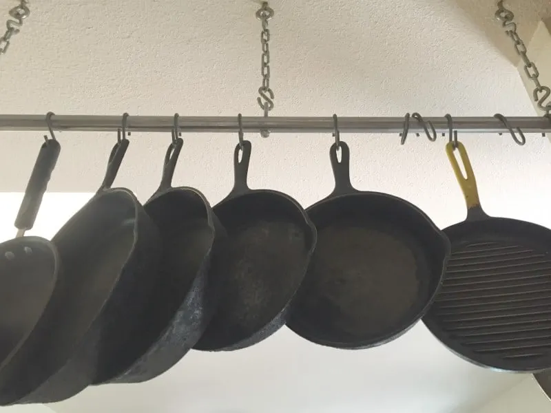 https://www.thescramble.com/wp-content/uploads/2019/02/hanging-pots-and-pans.opt_.jpg.webp