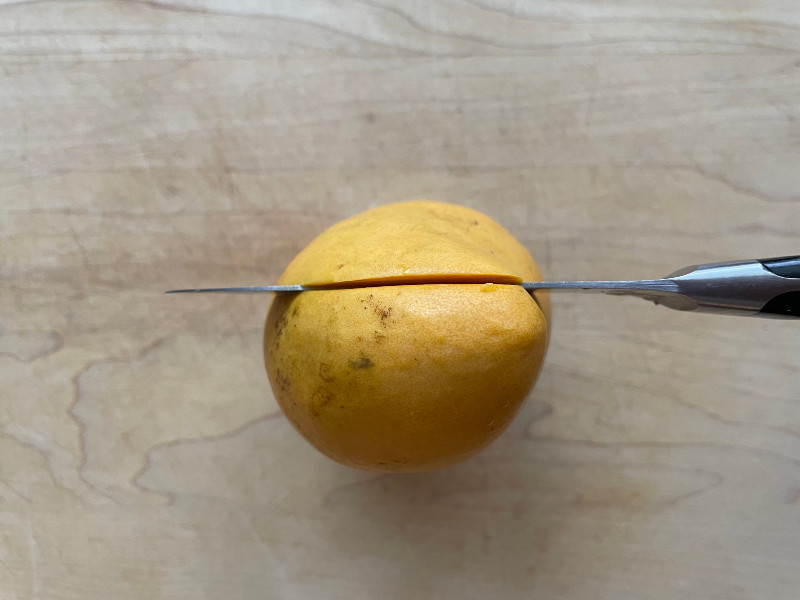 cutting into mango