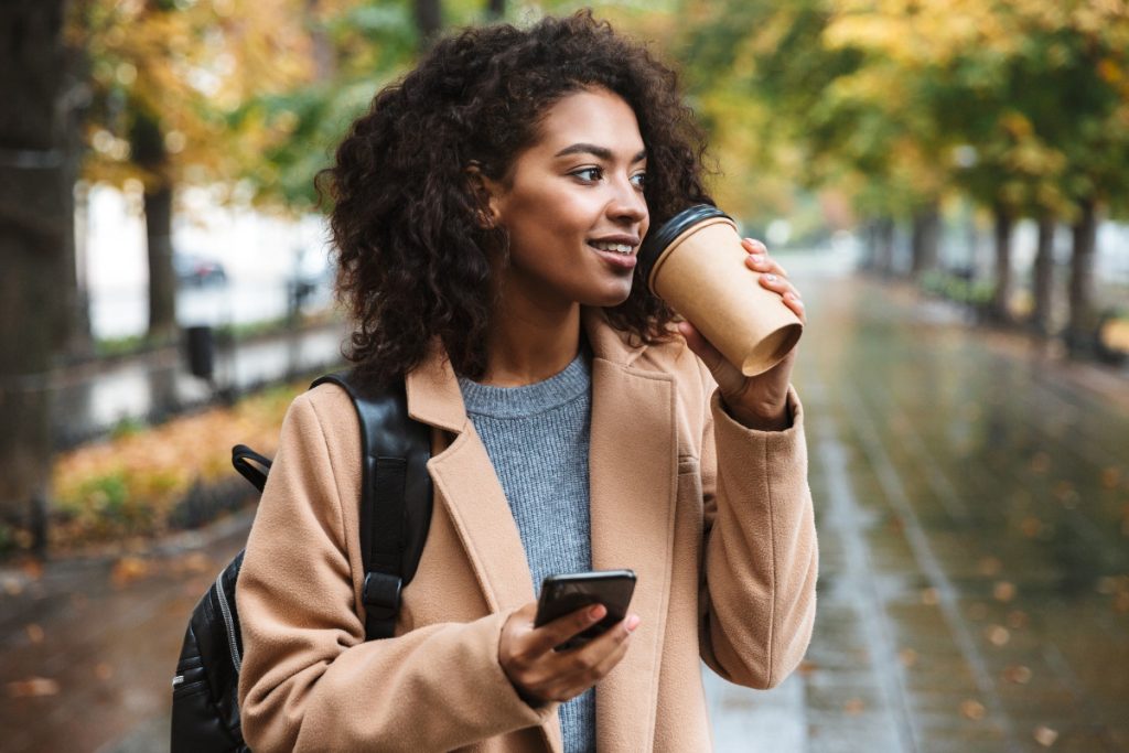 woman with coffee outside: an example of a small act of self-care