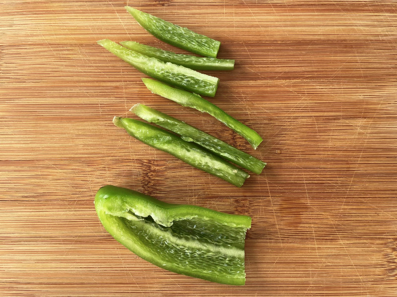 slicing jalapeno into strips