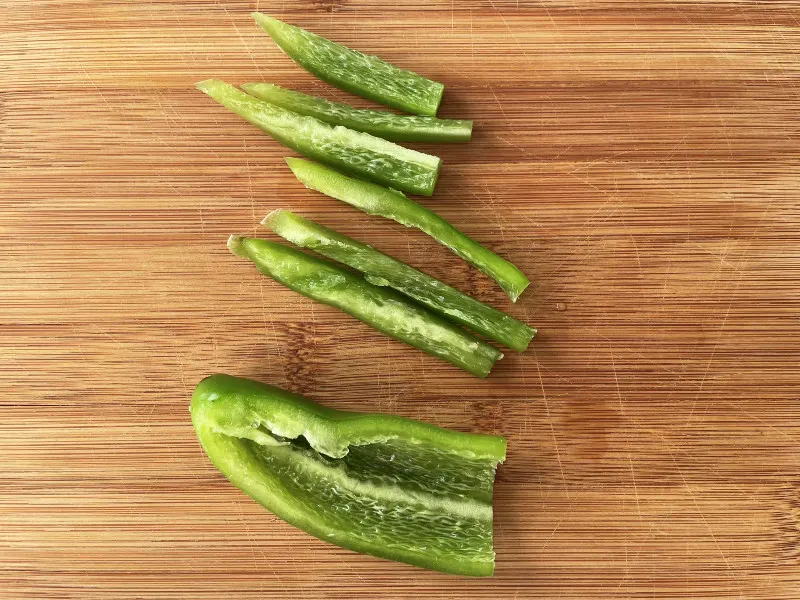 slicing jalapeno into strips