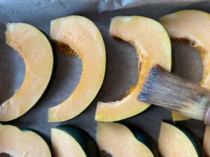 Oiling Acorn Squash Slices