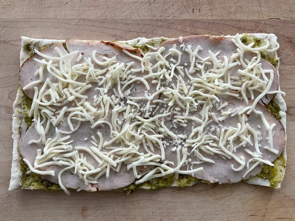 pinwheel dough with pesto, turkey, and cheese