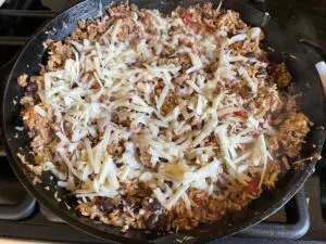 sprinkle cheese over skillet