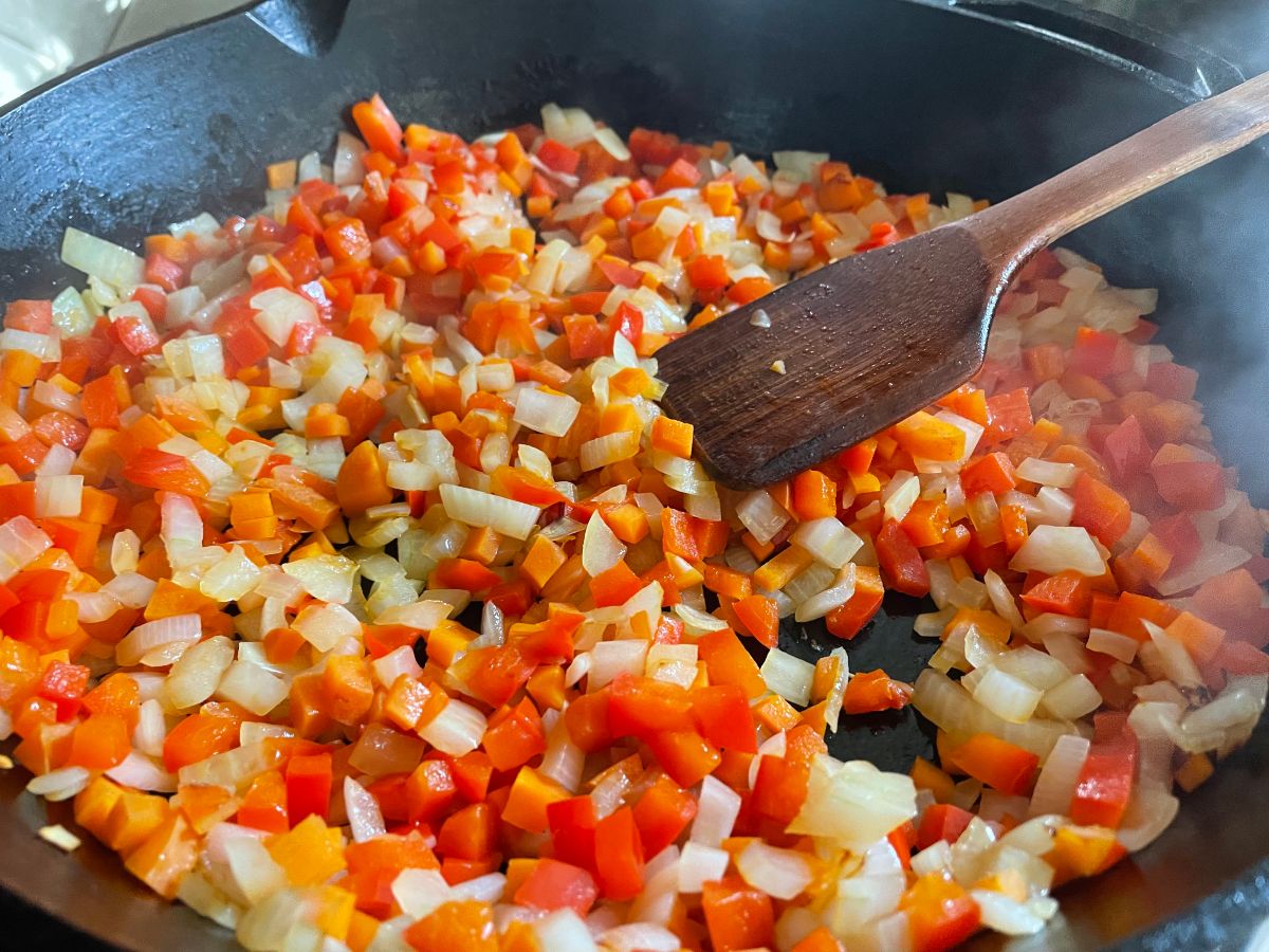 sauteed vegetables in a skillet: an example of a cooking task that someone could help you with in order to ease the burden of cooking