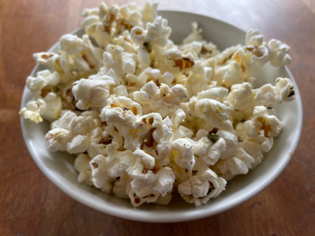 small bowl of popcorn with herb mix topping