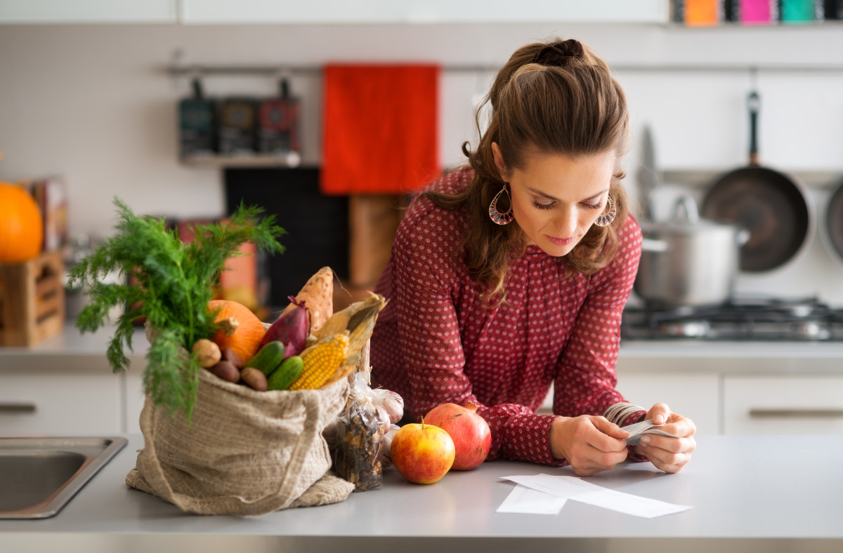easy ways to save on groceries: looking at the grocery receipt