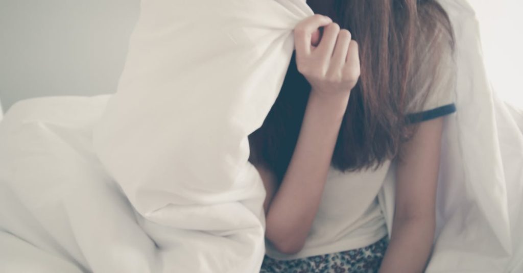 teen girl hiding face: how to support a teen who doesn't fit the mold